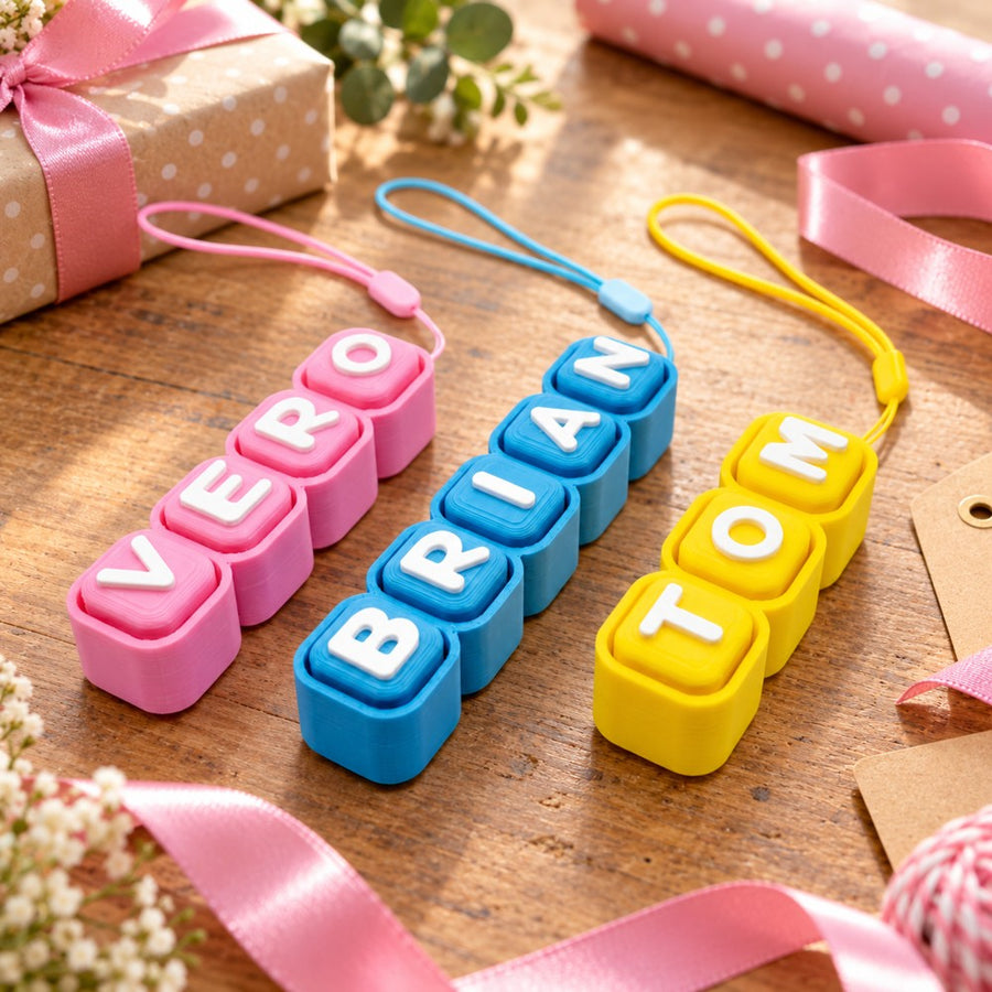 Colourful personalised name keychains styled with gifts and pink ribbon