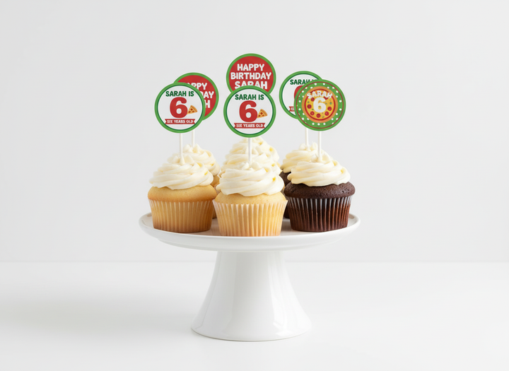 Cupcakes decorated with personalised pizza cupcake toppers that say Happy Birthday Sarah and Sarah is 6 in red and green designs on a white stand